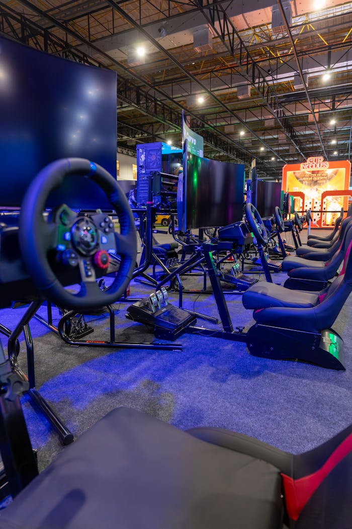 A modern setup of racing simulators in an indoor gaming arena with vibrant lighting.